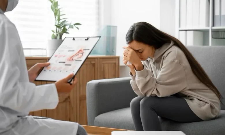 A lady with the doctor with her hands on her head