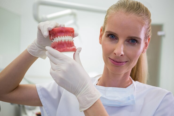 A dentist showing teeth in her hand