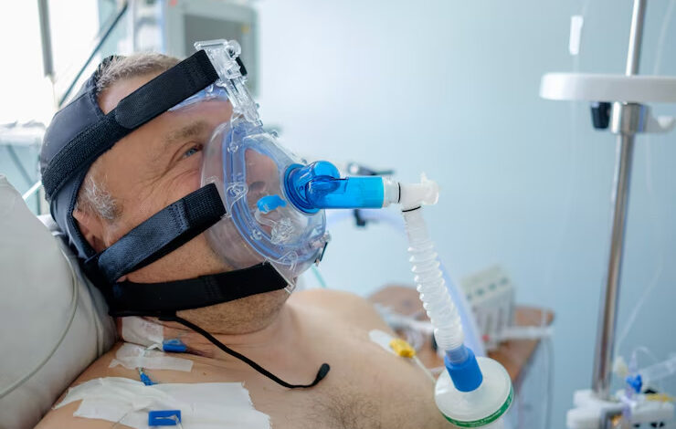 White male patient performs CPAP therapy using CPAP mask in intensive care department.
